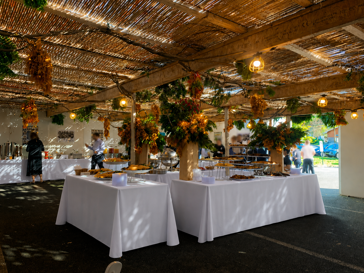 Covered kosher buffet with long white linens and warm lighting