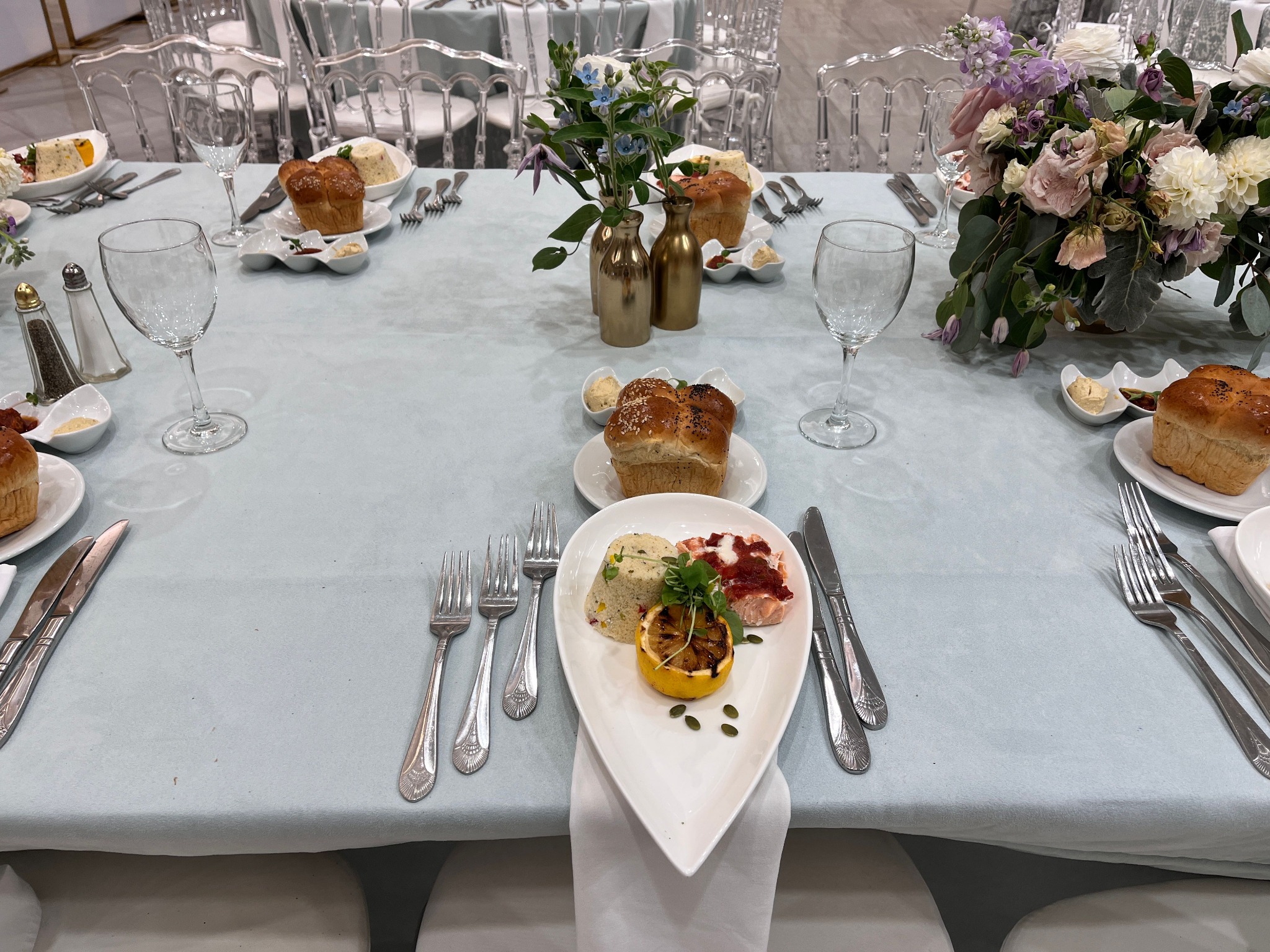 Formal kosher place setting with challah and plated service
